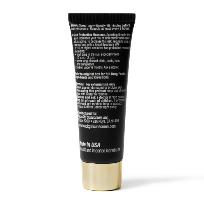 Back view of a black tube sunscreen with gold cap showing label text Black Girl Sunscreen SPF 45 for face and body