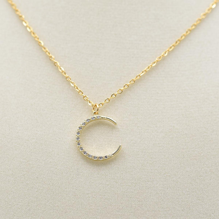 Gold Crescent Moon Gems Necklace on jewelry form