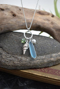 Ocean treasures charm pendant - sea glass jewelry featuring smooth frosted glass, handmade pewter shell, and elegant Swarovski crystal accents, perfect for ocean lovers.