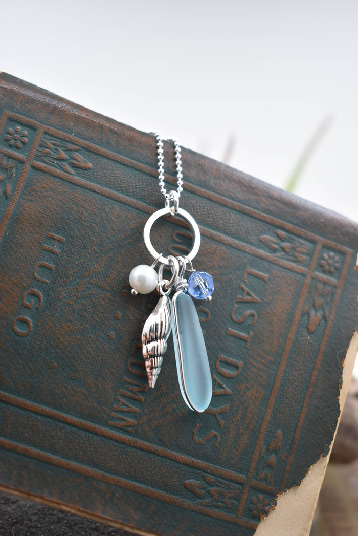 Close-up view of the Ocean treasures charm pendant highlighting the intricate frosted edges of eco-friendly sea glass jewelry.