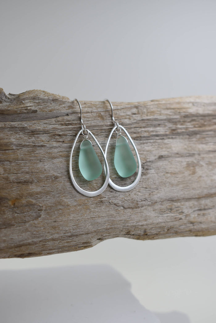 Close-up of Organic Eco glass earrings PERIWINKLE, featuring delicate open teardrop hoops made from .925 sterling silver.