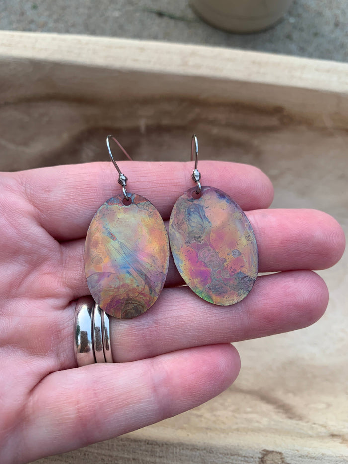 Fire-painted Oval Copper Earrings showcasing unique colorful patterns and a polished protective finish