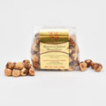 Packaged roasted salted hazelnuts with a visible brand label on a white background