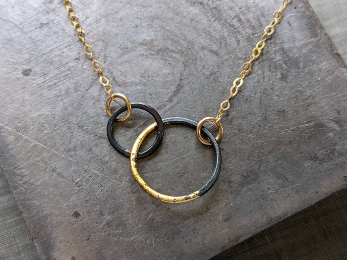 Petite Steel & Gold Interlocked Circles Necklace featuring brazed blackened steel circles accented with 23k gold—small in size, big on style.