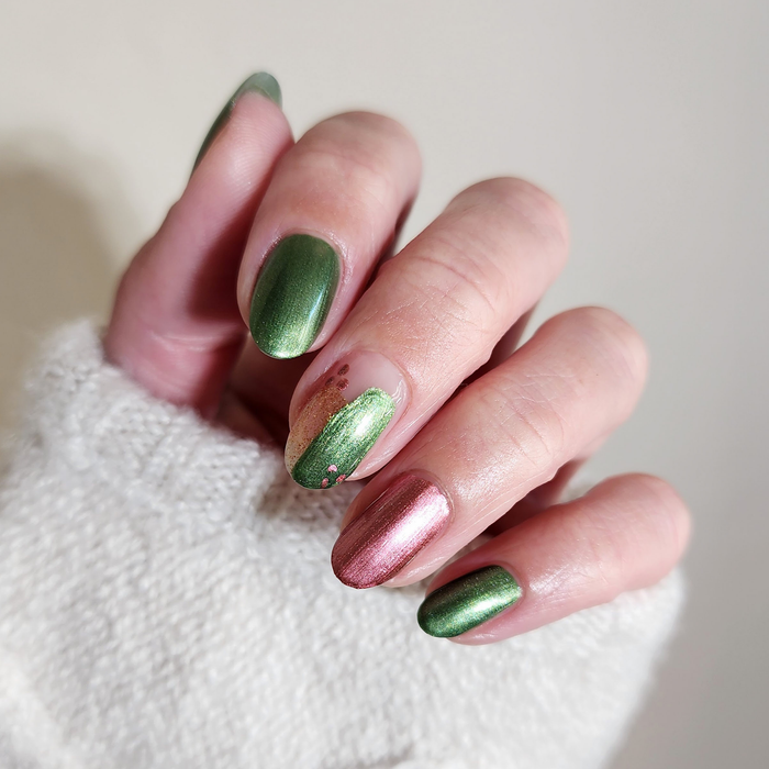 Rosy Quartz pink and Call Me Jade green shimmer mix-and-match manicure with a white sweater