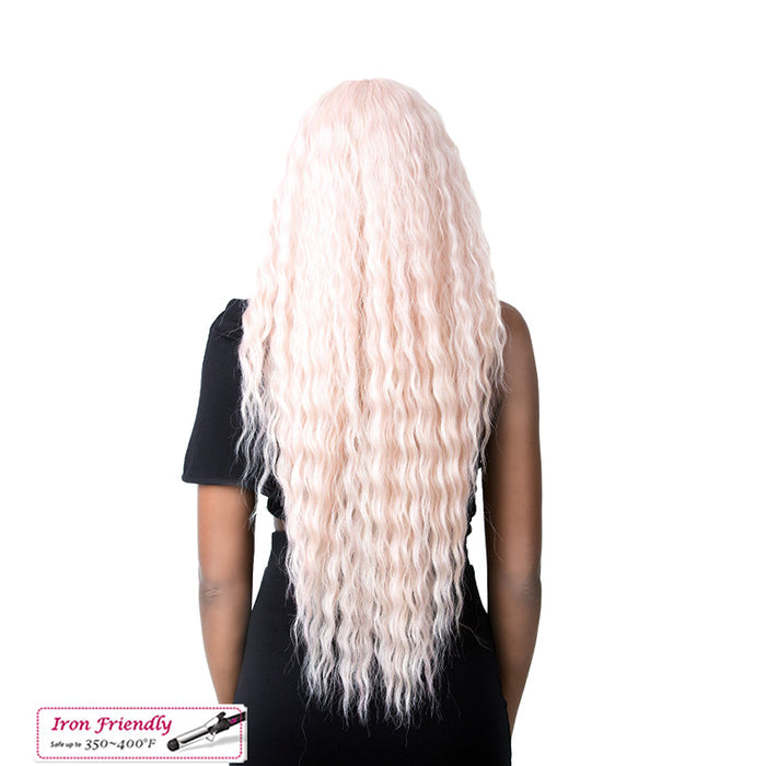 Rear view of model wearing ITS A WIG Swiss lace wig long wavy pastel pink extra long hair
